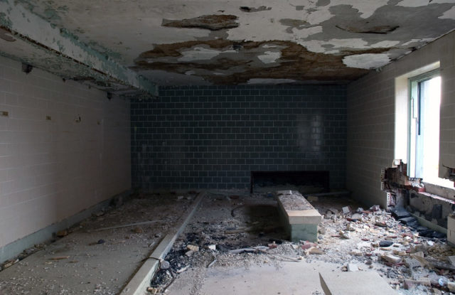 Empty room with a cement bench in the center