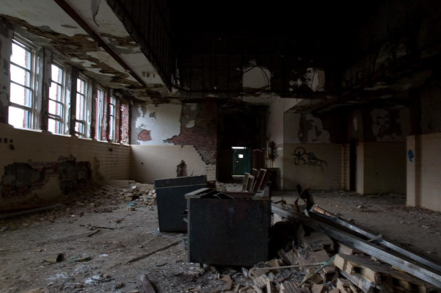 Darkened room with debris strewn across the floor