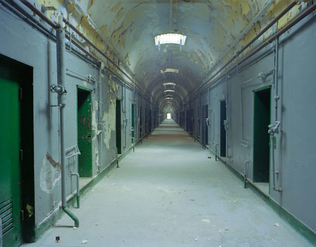 Empty hallway lit by overhead lights