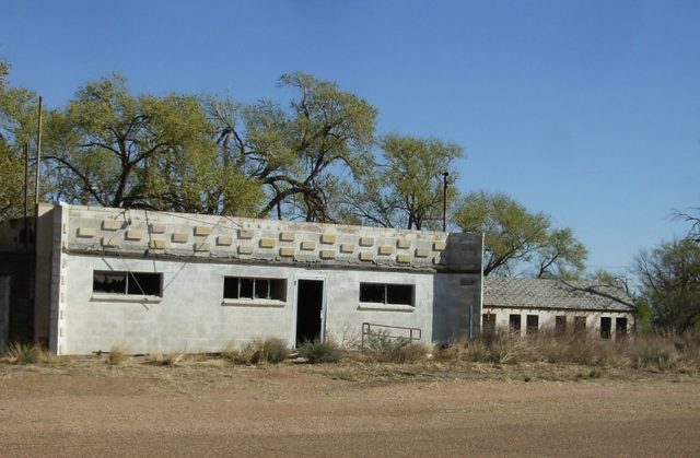 Cement building along a dirt road