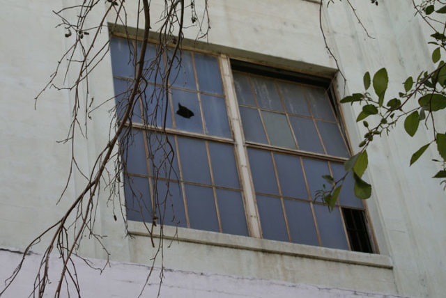 Looking up at a broken window on the exterior of the Lincoln Heights Jail