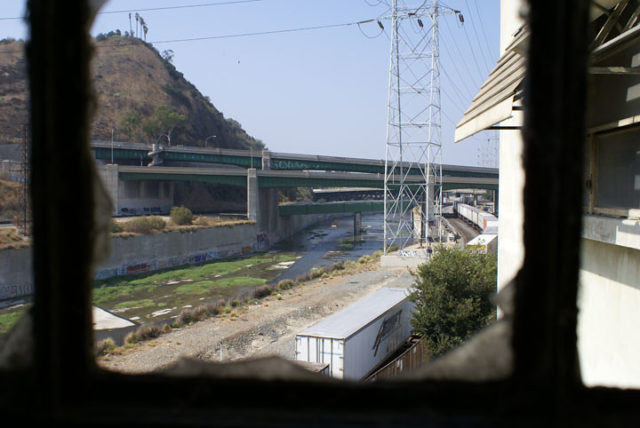 View of the exterior of Lincoln Heights Jail from a broken window pane