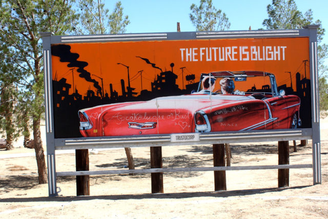 Orange billboard featuring a red convertible