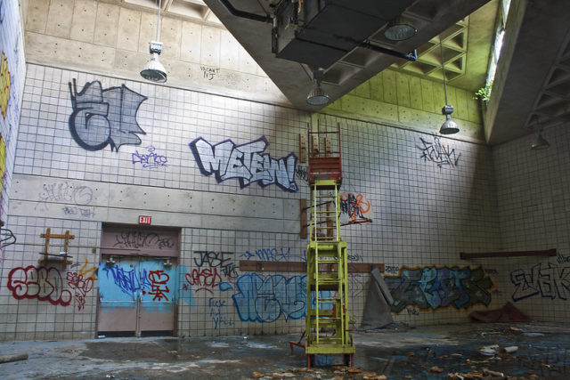 Lifeguard chair in a graffiti-covered room