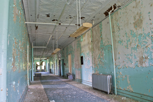 Hallway with peeling turquoise paint at the Hudson River State Hospital