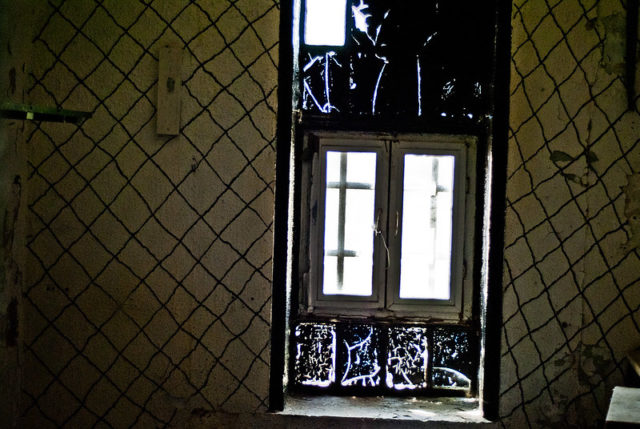 Darkened room lit only by a window