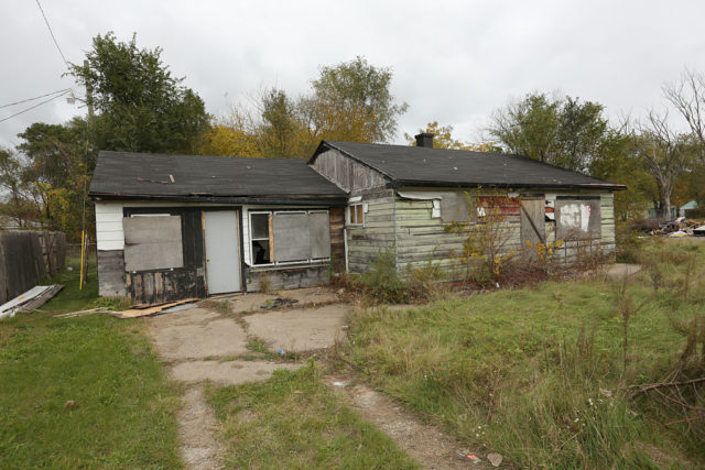 Dilapidated home with boarded windows