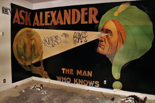 "ASK ALEXANDER" painting on the wall