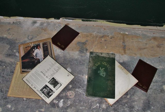 Books and paper strewn across the ground