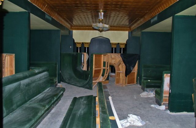 Velvet green dining booths covered in dust