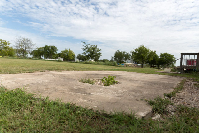 Concrete foundation surrounded by grass