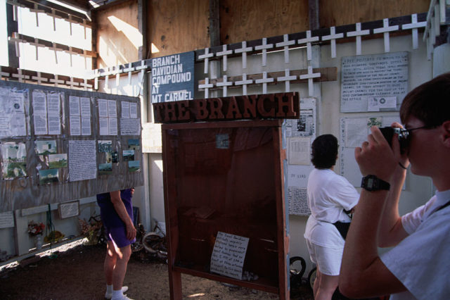 Visitors looking at displays on the inside walls of a building