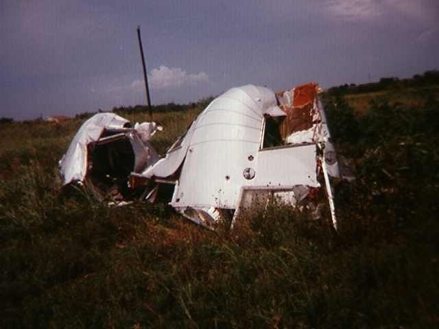 Broken trailer in tall grass