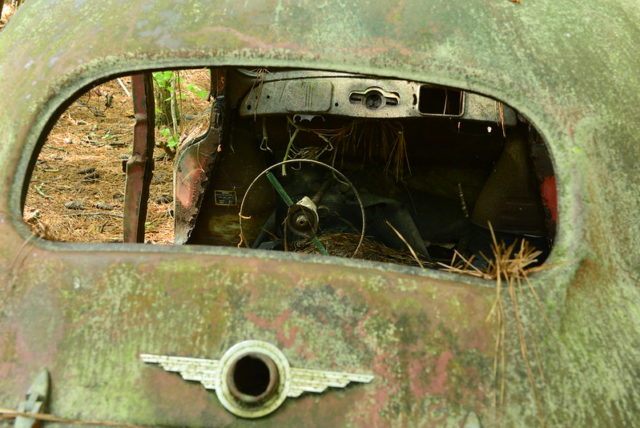 Old car with its back window knocked out