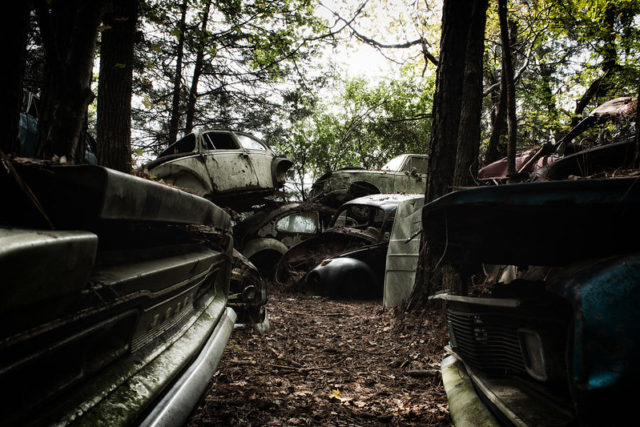 Rusty cars piled atop each other at Old Car City