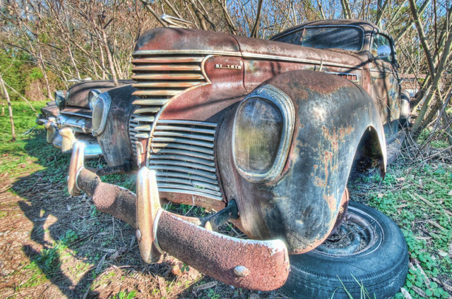 Rusty pickup truck with its tires broken off