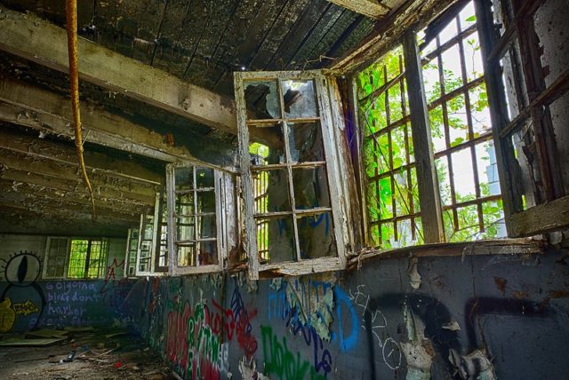 Graffiti-covered wall with open windows
