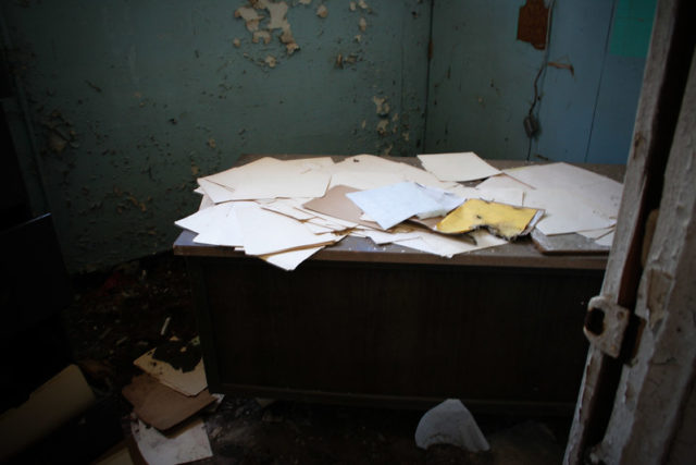 Table covered in loose paper