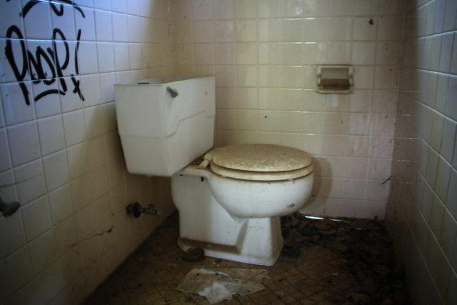 Toilet in the corner of a room