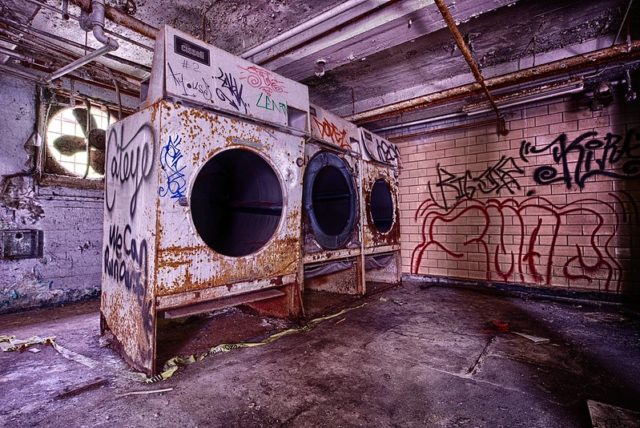 Rusty and graffiti-covered washing machines