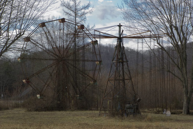Rusty Ferris wheel and wooden swings