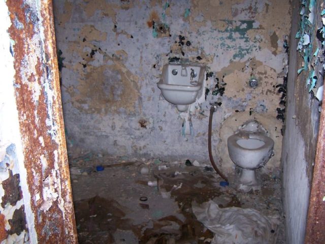 Toilet and sink in a derelict room