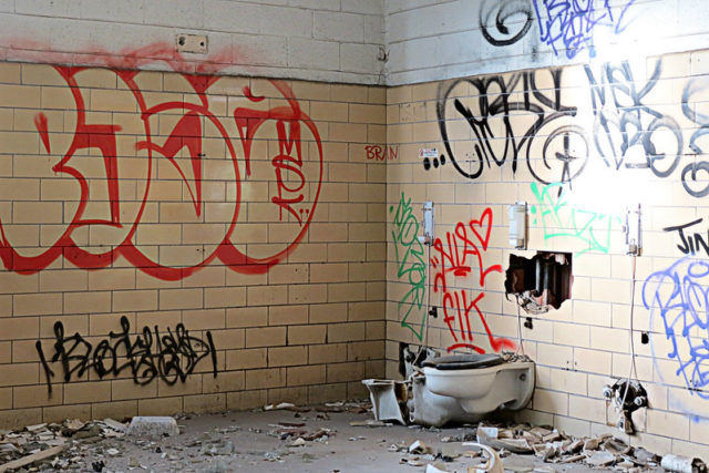 Graffiti-covered toilet stall