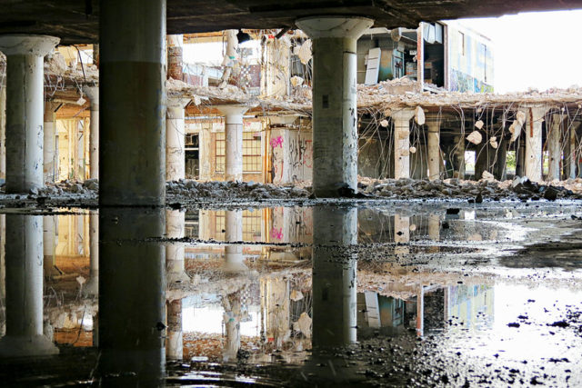 Water-covered floor with cement pillars