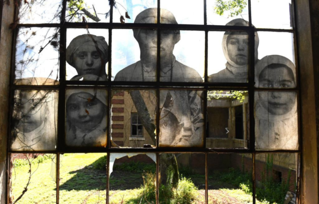 Photographs of immigrants on a window at the Ellis Island Immigrant Hospital