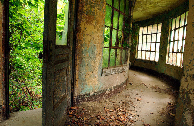 Open door leading to an empty hallway