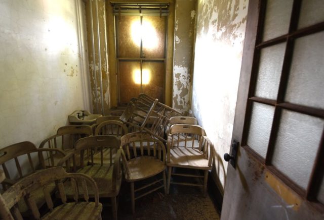 Stacked chairs in a small room