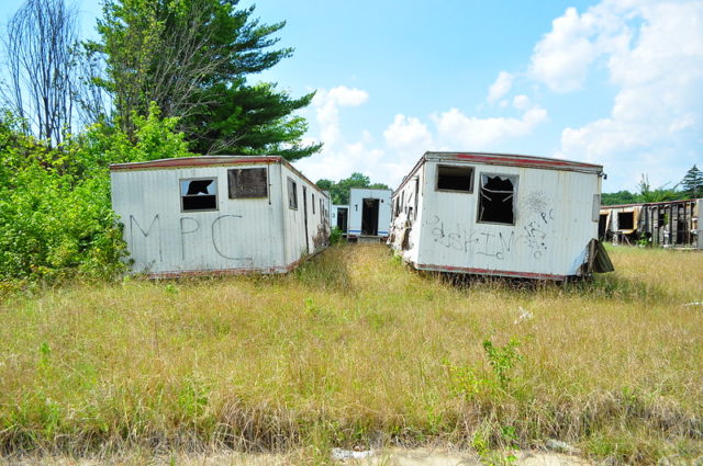 Rundown portables in overgrown grass