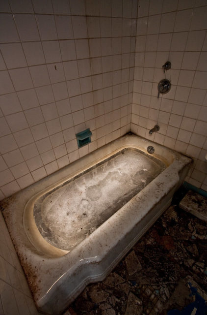 Dirty bathtub in a hotel room bathroom