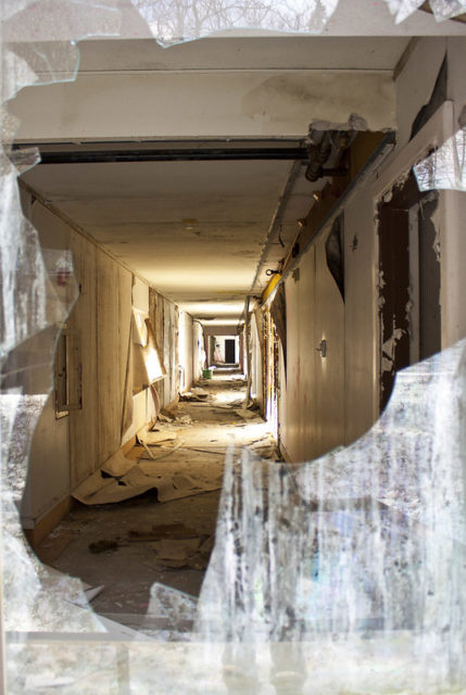 Looking into a hallway through a broken window