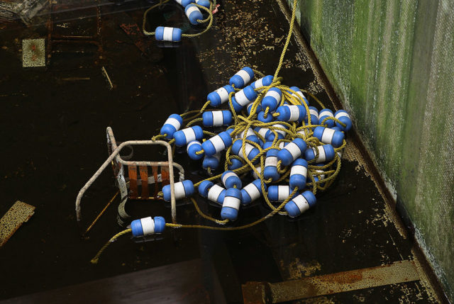 Pool markers piled at the bottom of an empty swimming pool