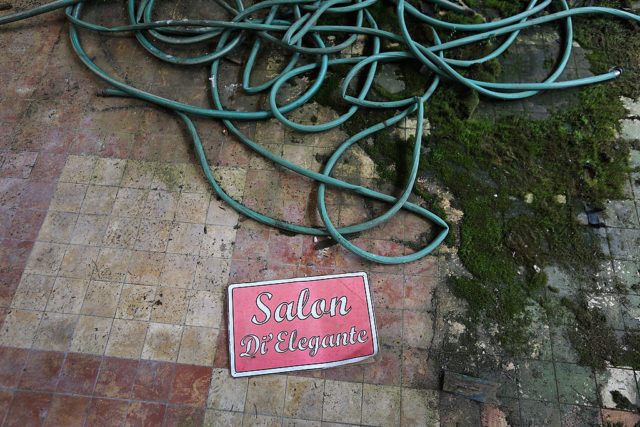 Pink salon sign on the ground