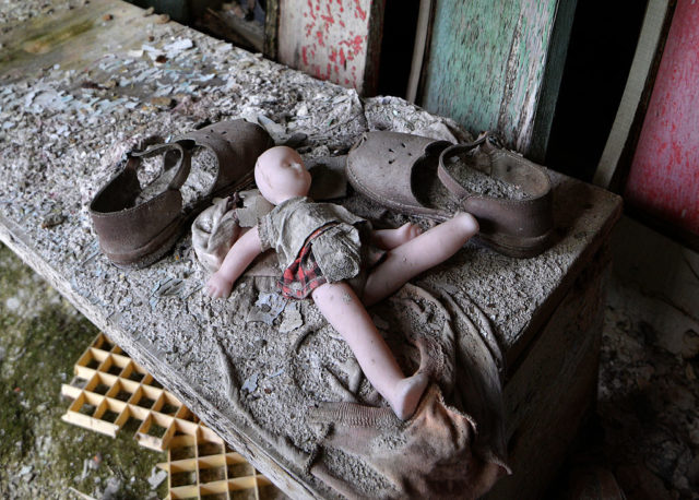 Doll and shoes on a bench in a nursery