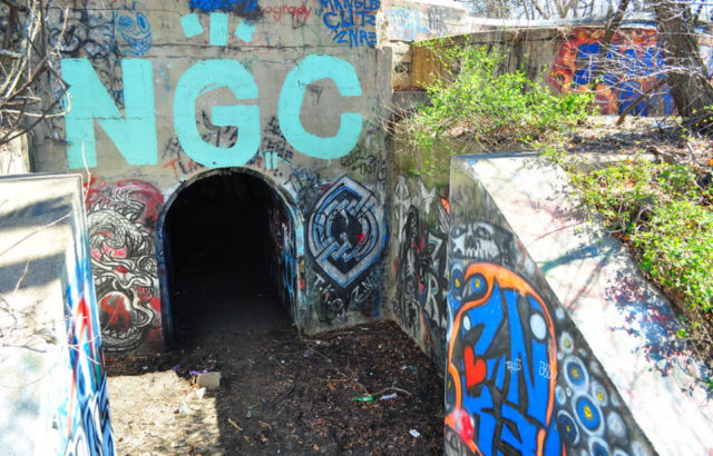 Graffiti-covered tunnel entryway