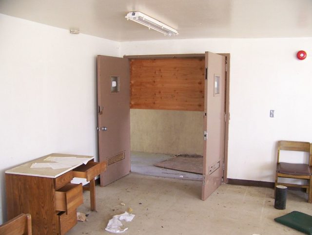 Abandoned dormitory with a wooden desk