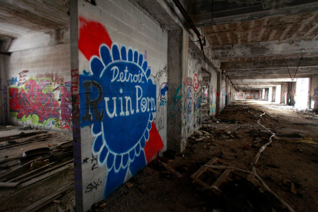 Graffiti covered wall in a darkened hallway