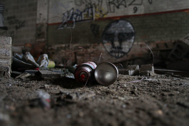 Spray paint cans on the ground