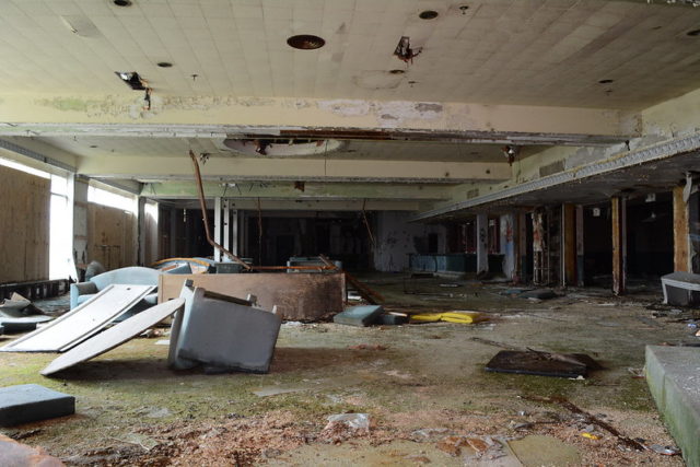 Overturned furniture in a debris-filled room