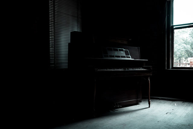 Piano in a darkened room