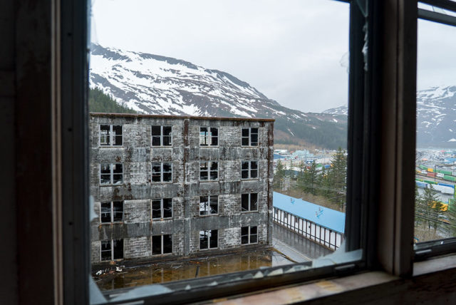 View of the exterior of the Buckner Building through a broken window