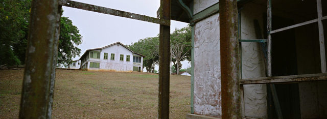 View of a home through broken windows