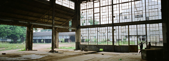 Broken windows as seen from the interior of a warehouse