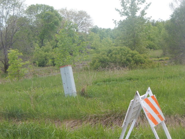 Green space with a warning barrier placed in the middle