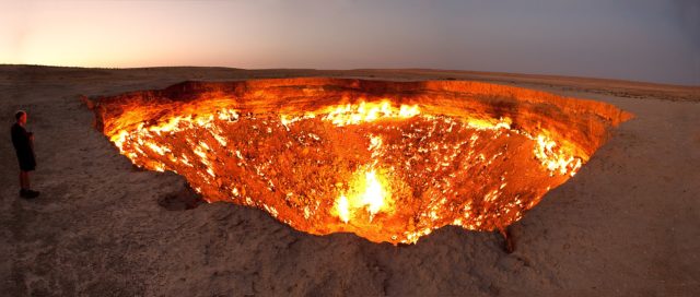 Man standing beside the Darvaza gas crater