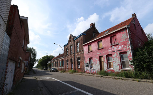 Boarded-up buildings along a street in Doel