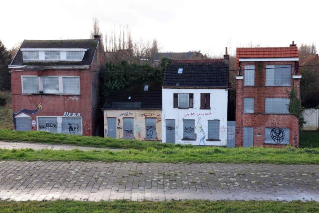 Three boarded-up houses in Doel